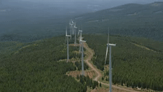 Digital image of outdoor large windmills turning to illustrate the subject of Environmental Science